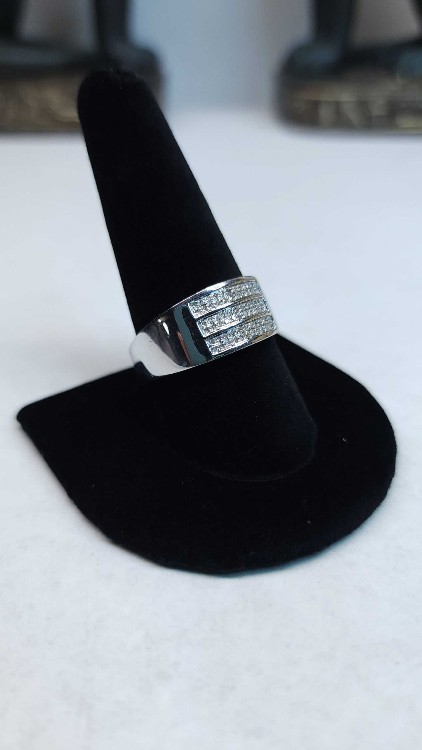 This triple row of 0.20 ctw all Natural Diamonds on a 10k white gold (WG) band is sized for a 10.5 ring finger. This bulky piece is professional and bold at the same time and perfect for daily wear or special nights out.