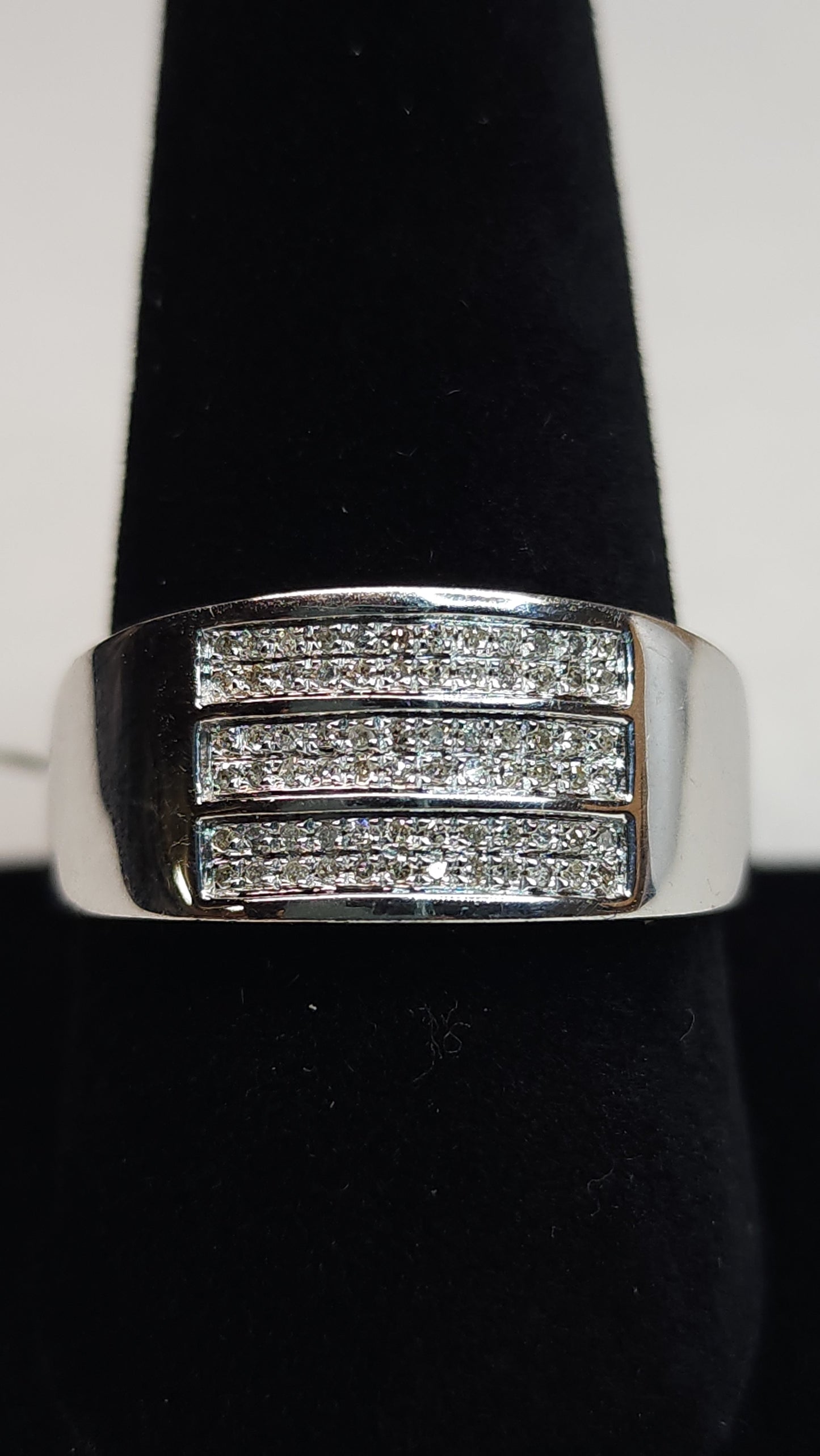 This triple row of 0.20 ctw all Natural Diamonds on a 10k white gold (WG) band is sized for a 10.5 ring finger. This bulky piece is professional and bold at the same time and perfect for daily wear or special nights out.